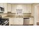 Bright kitchen features granite counters, stainless appliances, and a window over the sink at 1922 Willa Dr, Decatur, GA 30032