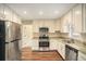 Updated kitchen features stainless steel appliances, granite counters, and white cabinets at 1922 Willa Dr, Decatur, GA 30032