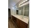 Bathroom featuring a double vanity, a walk-in closet, and a glass-door shower at 1965 Nocturne Dr # 1103, Alpharetta, GA 30009