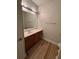 Bathroom with wood-look flooring, a vanity with a mirror, and modern lighting at 1965 Nocturne Dr # 1103, Alpharetta, GA 30009