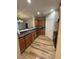 Well-lit kitchen with stainless steel appliances, dark countertops and wood floors at 1965 Nocturne Dr # 1103, Alpharetta, GA 30009