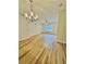 Bright living room with hardwood floors, a ceiling fan, and a modern chandelier at 1965 Nocturne Dr # 1103, Alpharetta, GA 30009