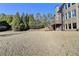 Expansive backyard featuring a well-maintained lawn, a deck and lush green trees at 4360 Autry Way, Alpharetta, GA 30022