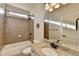 Bathroom features a tub, tile surround, vanity, and ample lighting for a functional and stylish space at 4360 Autry Way, Alpharetta, GA 30022