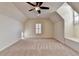 Large carpeted bedroom featuring a ceiling fan and bright natural light at 4360 Autry Way, Alpharetta, GA 30022