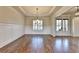 Elegant dining room features hardwood floors, white wainscoting, plantation shutters, and modern chandelier at 4360 Autry Way, Alpharetta, GA 30022