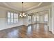 Elegant dining room featuring hardwood floors, white wainscoting, plantation shutters, and modern chandelier at 4360 Autry Way, Alpharetta, GA 30022