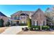 Beautiful brick home with manicured landscaping, and a concrete driveway at 4360 Autry Way, Alpharetta, GA 30022