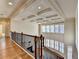 View from second story overlooking foyer, staircase, and window lined living room at 4360 Autry Way, Alpharetta, GA 30022