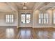 Bright foyer features hardwood floors, a tray ceiling, and glass panel double doors at 4360 Autry Way, Alpharetta, GA 30022