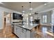 Open kitchen featuring granite countertops, stainless steel appliances, and island with sink at 4360 Autry Way, Alpharetta, GA 30022