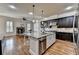 Kitchen with large island, granite countertops, stainless steel appliances, and hardwood floors at 4360 Autry Way, Alpharetta, GA 30022