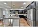 Open kitchen featuring granite countertops, stainless steel appliances, and dark wood cabinetry at 4360 Autry Way, Alpharetta, GA 30022