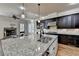 Island with granite countertop, stainless steel sink, and pendant lighting at 4360 Autry Way, Alpharetta, GA 30022