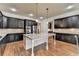 Kitchen with granite countertops, stainless steel appliances, and island with breakfast bar at 4360 Autry Way, Alpharetta, GA 30022