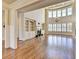 Bright living room featuring hardwood floors, fireplace with built-ins, large windows and modern chandelier at 4360 Autry Way, Alpharetta, GA 30022
