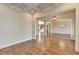 Open-concept living space with hardwood floors, white trim, and elegant light fixtures at 4360 Autry Way, Alpharetta, GA 30022