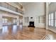 Bright living room featuring hardwood floors, fireplace with built-ins, large windows and modern chandelier at 4360 Autry Way, Alpharetta, GA 30022
