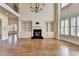 Bright living room featuring hardwood floors, fireplace with built-ins, large windows and modern chandelier at 4360 Autry Way, Alpharetta, GA 30022