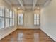 Inviting living area featuring hardwood floors, white trim, and large shuttered windows at 4360 Autry Way, Alpharetta, GA 30022