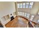 Two-story living room with fireplace, custom built-ins, and large windows with a view of the neighborhood at 4360 Autry Way, Alpharetta, GA 30022