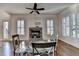 Living area with fireplace, hardwood floors, and natural light from shuttered windows at 4360 Autry Way, Alpharetta, GA 30022