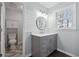 This bathroom has a vanity with drawers and an oval mirror over the sink and toilet in its own room at 710 Melanie Ct, Canton, GA 30115