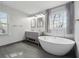 Modern bathroom with a double vanity, soaking tub, separate shower and lots of natural light at 710 Melanie Ct, Canton, GA 30115