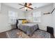 Comfortable bedroom with a ceiling fan, hardwood floors, natural light, and accent rug at 710 Melanie Ct, Canton, GA 30115