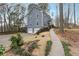 Multi-story home with landscaped front and driveway leading to a two-car garage at 710 Melanie Ct, Canton, GA 30115