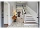 Inviting home entryway with brick floors, staircase, and neutral decor at 710 Melanie Ct, Canton, GA 30115
