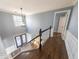 Hallway with hardwood floors, white banister, and a view of the front door at 710 Melanie Ct, Canton, GA 30115