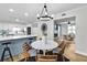 Open-concept dining area with white kitchen and a view to living area with fireplace at 3825 Lavista Rd # Q3, Tucker, GA 30084