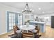 Dining area with seating for four and view of the yard from the blue-framed glass patio doors at 3825 Lavista Rd # Q3, Tucker, GA 30084