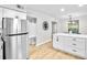 Kitchen with stainless steel refrigerator and a stylish island featuring white countertop and shaker cabinets at 3825 Lavista Rd # Q3, Tucker, GA 30084