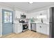 Well-lit kitchen with sleek stainless steel appliances and white cabinets offering ample storage space at 3825 Lavista Rd # Q3, Tucker, GA 30084