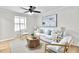 Cozy living room with light walls, wood floors, ceiling fan and comfortable seating arrangement at 3825 Lavista Rd # Q3, Tucker, GA 30084