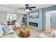 Modern living room featuring a fireplace, light wood floors, and bright furniture at 3825 Lavista Rd # Q3, Tucker, GA 30084