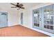Bright sunroom features painted wood floor, ceiling fan, and access doors at 3825 Lavista Rd # Q3, Tucker, GA 30084