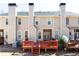 Exterior view of the back of the townhome featuring a wooden deck and three chimneys at 4766 Longcourt Se Dr, Atlanta, GA 30339