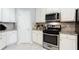 Kitchen featuring stainless steel appliances, granite countertops, white cabinetry, and a modern design at 4766 Longcourt Se Dr, Atlanta, GA 30339