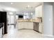 Open kitchen with stainless steel appliances, white cabinets, and view into the living area at 4766 Longcourt Se Dr, Atlanta, GA 30339