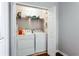 Convenient laundry closet featuring washer, dryer and wire shelving at 4766 Longcourt Se Dr, Atlanta, GA 30339
