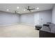 Spacious living room with carpet, ceiling fans, and ample lighting at 4766 Longcourt Se Dr, Atlanta, GA 30339