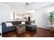 Comfortable living area with dark wood floors, a gray sectional sofa, and views of the kitchen at 4766 Longcourt Se Dr, Atlanta, GA 30339