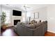 Inviting living room with a fireplace, large TV, a comfortable gray couch, and bright windows at 4766 Longcourt Se Dr, Atlanta, GA 30339