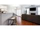 Open concept living room with stainless steel appliances, hardwood floors, and plenty of natural light at 4766 Longcourt Se Dr, Atlanta, GA 30339