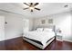 Comfortable main bedroom with tray ceilings, hardwood floors, and a neutral color palette at 4766 Longcourt Se Dr, Atlanta, GA 30339