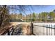 Community tennis courts with trees, fencing and walkway at 4766 Longcourt Se Dr, Atlanta, GA 30339