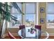 The dining area features a modern glass table and chairs with city views from the large paned windows at 57 Forsyth St # 13D, Atlanta, GA 30303